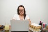 woman in white shirt sitting by the table smiling-scopio-08cfa70f-938b-439b-9a8c-72bcc74f911e